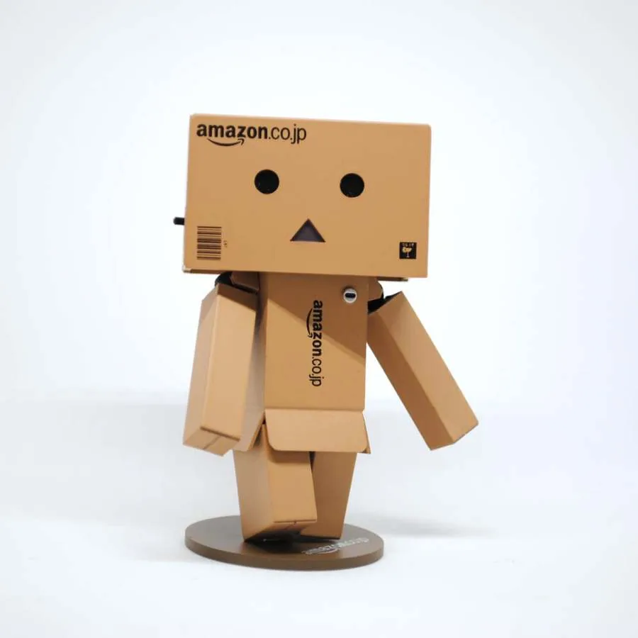 Small cardboard robot figure made from an Amazon box